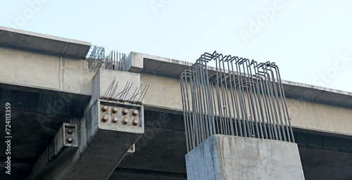 TMT bars or rebars jutting out of unfinished pillars and beams at an ongoing flyover project