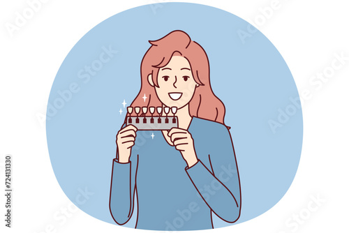 Woman holds device to determine shade of teeth passes test for quality of toothpaste. Long-haired girl demonstrates snow-white smile after whitening procedure at dentist. Flat vector illustration