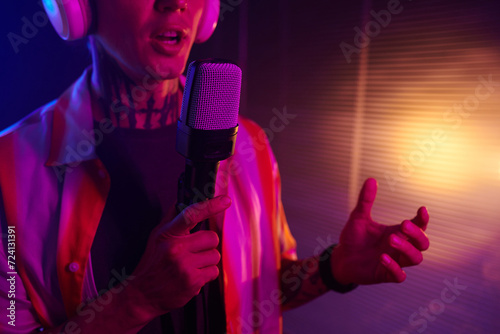Cropped image of performer singing song in microphone