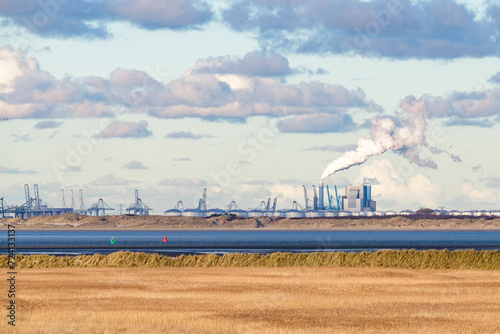 Industry, wind turbines and the coal-fired power station at the Maasvlakte, Port of Rotterdam, seen from the island Goeree-Overflakkee at the North Sea coast in the southwest of The Netherlands. photo