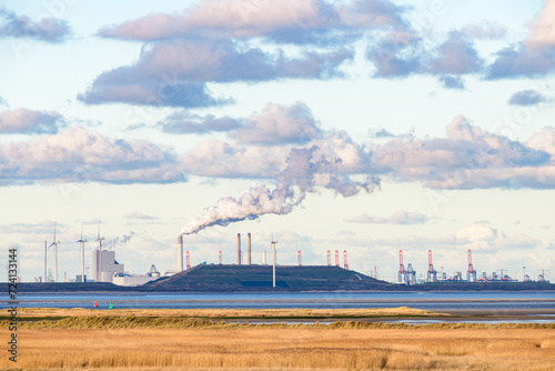 Industry  wind turbines and the coal-fired power station at the Maasvlakte  Port of Rotterdam  seen from the island Goeree-Overflakkee at the North Sea coast in the southwest of The Netherlands.