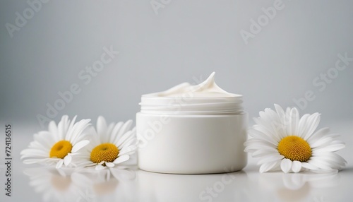 empty cosmetic cream container and daisy flower plant decor in white color  isolated white color  