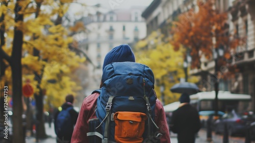 Young tourist wearing a ruck sack wanders round the city streets photo
