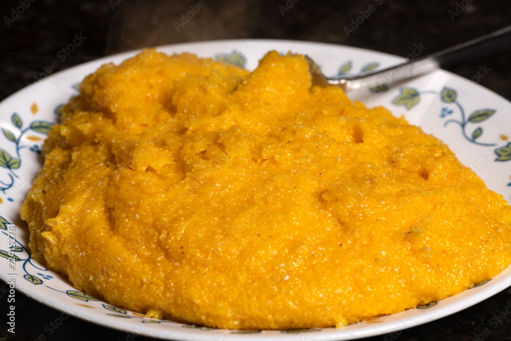 Polenta on plate ready to serve. A traditional cornmeal food. Polenta on plate ready to serve. A traditional cornmeal food.