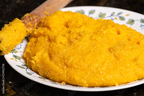 Polenta on plate ready to serve. A traditional cornmeal food.