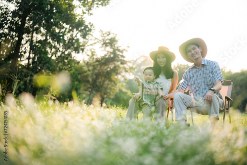 happy harmonious family outdoors concept father and mother and son have activities together on holidays, nature grassland field