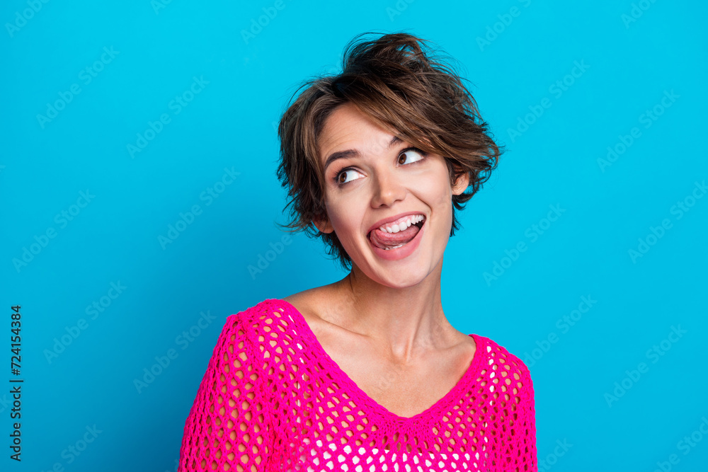 Fototapeta premium Photo of positive crazy woman wear knitted neon shirt stick out looking empty space isolated blue color background