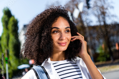 Close up portrait of adorable lovely pretty girl hand touch wavy hair walk in city center go cafe shopping free time weekend #724161702