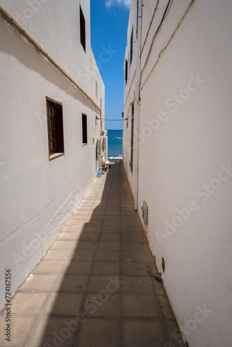 Seascape. Alley facing the sea. Fishing village of Arrieta. Houses with white walls and blue windows. Lanzarote architecture. Lanzarote  Canary Islands  Spain