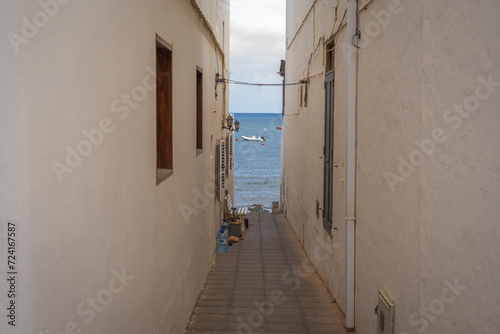 Seascape. Alley facing the sea. Fishing village of Arrieta. Houses with white walls and blue windows. Lanzarote architecture. Lanzarote, Canary Islands, Spain