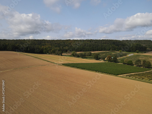 Aerial view of farm fields with plowed soil in the countryside 