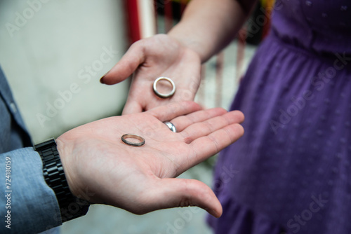 two people holding wedding rings in each hand with fingers out