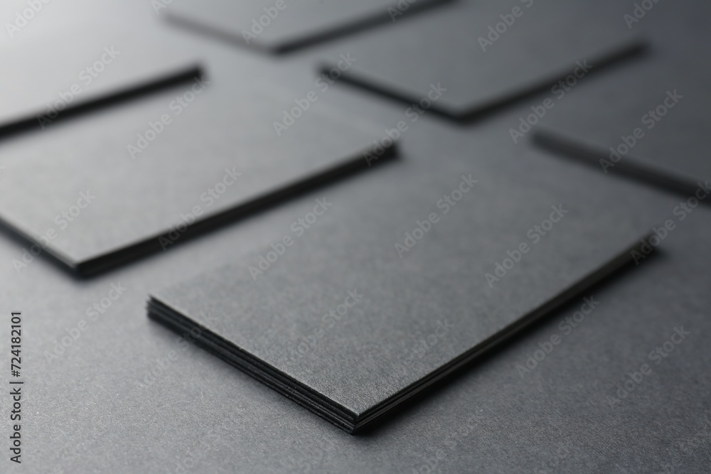 Blank business cards on black background, closeup. Mockup for design