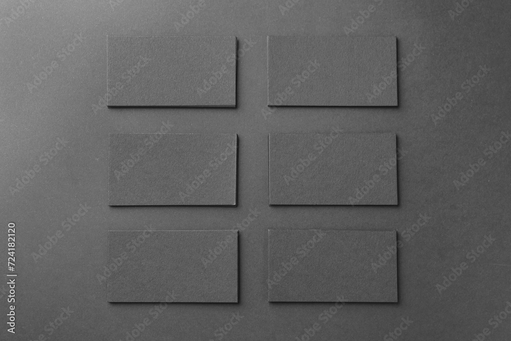 Obraz premium Blank business cards on black background, flat lay. Mockup for design