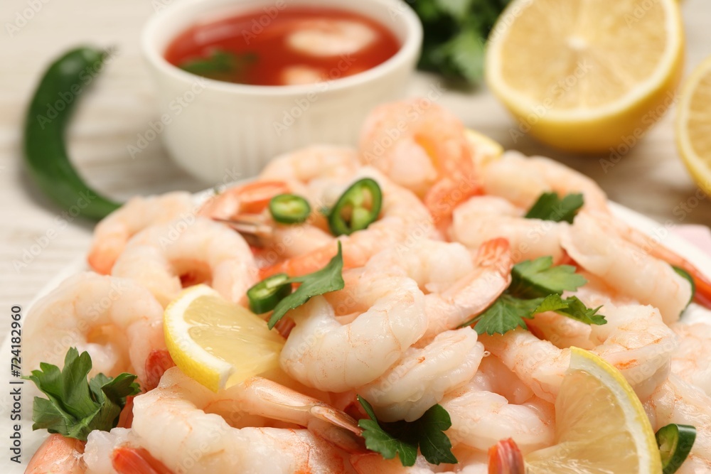Tasty boiled shrimps with cocktail sauce, chili and parsley on table, closeup Tasty boiled shrimps with cocktail sauce, chili and parsley on table, closeup