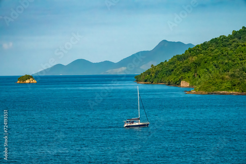 Saling along the coast of Ilha Grande island, Rio de Janeiro, Brazil. The island interior is a nature reserve and beaches are only accessible by boat