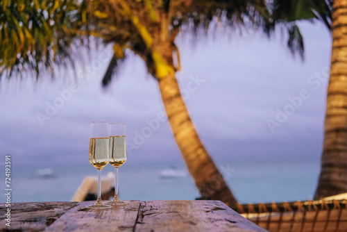 Wallpaper Mural Two glasses of champagne in an outdoor cafe on an island, palm trees, sea, sunset  Torontodigital.ca