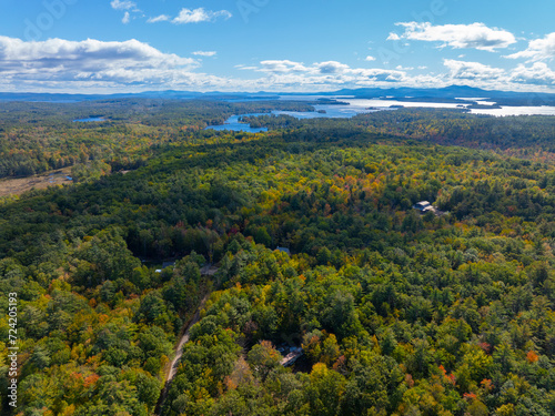 Aerial view of Lake Winnipesaukee with sunshine through clouds in fall from town of Moutonborough, New Hampshire NH, USA. 