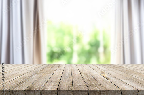 Wooden table on window background with garden and trees
