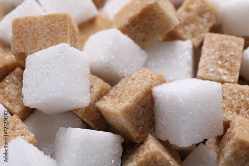 White and brown sugar cubes as background, closeup