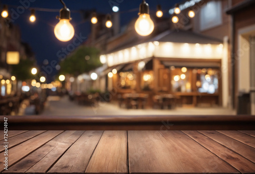 Empty wooden table and bokeh lights blurred cafe background, product presentation concept