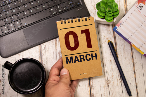 March 1 calendar date text on wooden blocks with blurred park background. Copy space and calendar concept