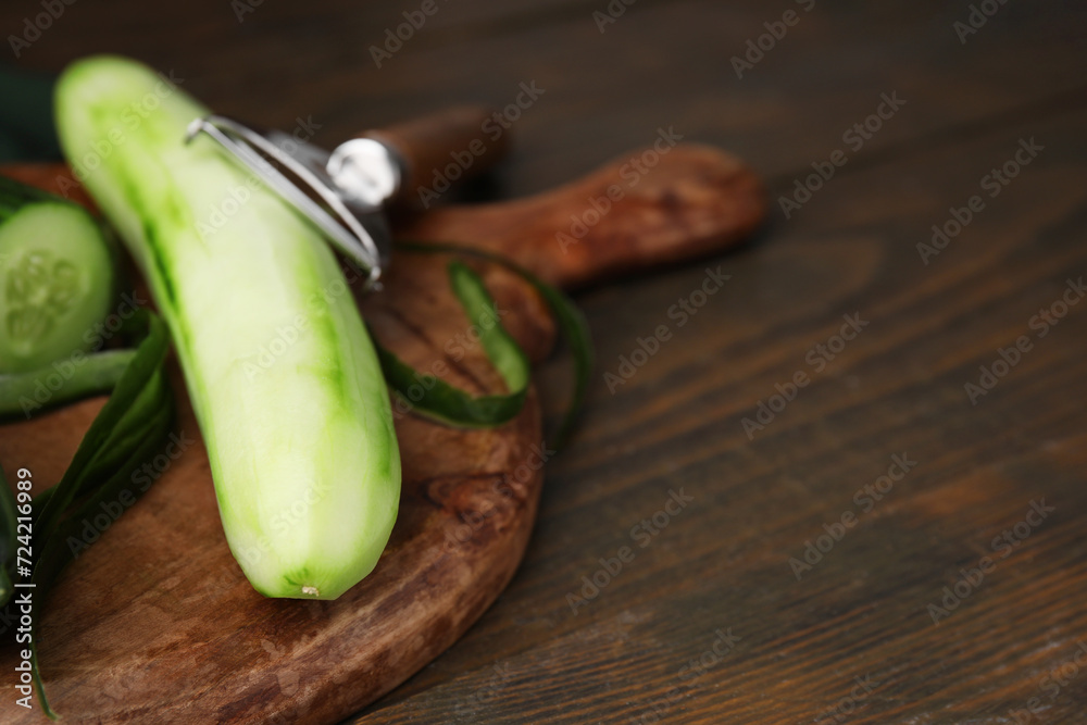 Fresh cucumbers on wooden table, closeup. Space for text Fresh cucumbers on wooden table, closeup. Space for text