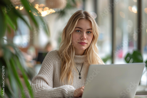 a young woman using a laptop in an office