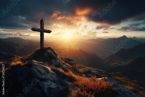 old solitary cross on a rock in a cloudy mountain landscape at sunset or sunrise