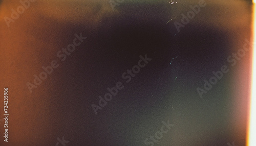 Designed film texture background with heavy grain, dust and a light leak Real Lens Flare Shot in Studio over Black Background. Easy to add as Overlay or Screen Filter over Photos overlay
