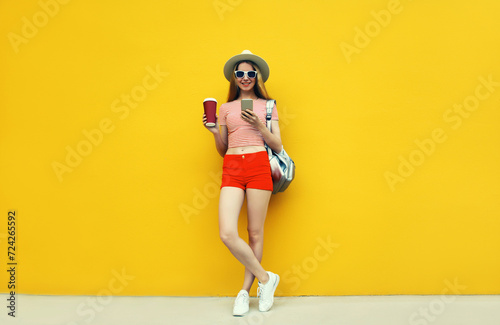 Summer image of traveler young woman 20s with mobile phone looking at device