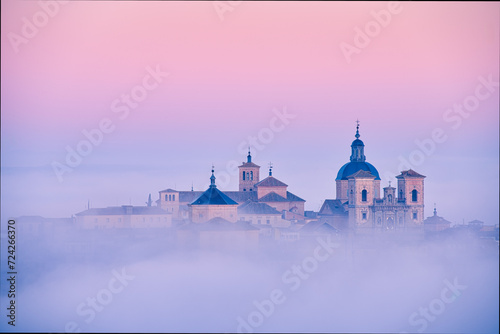Foggy sunrise over historical buildings