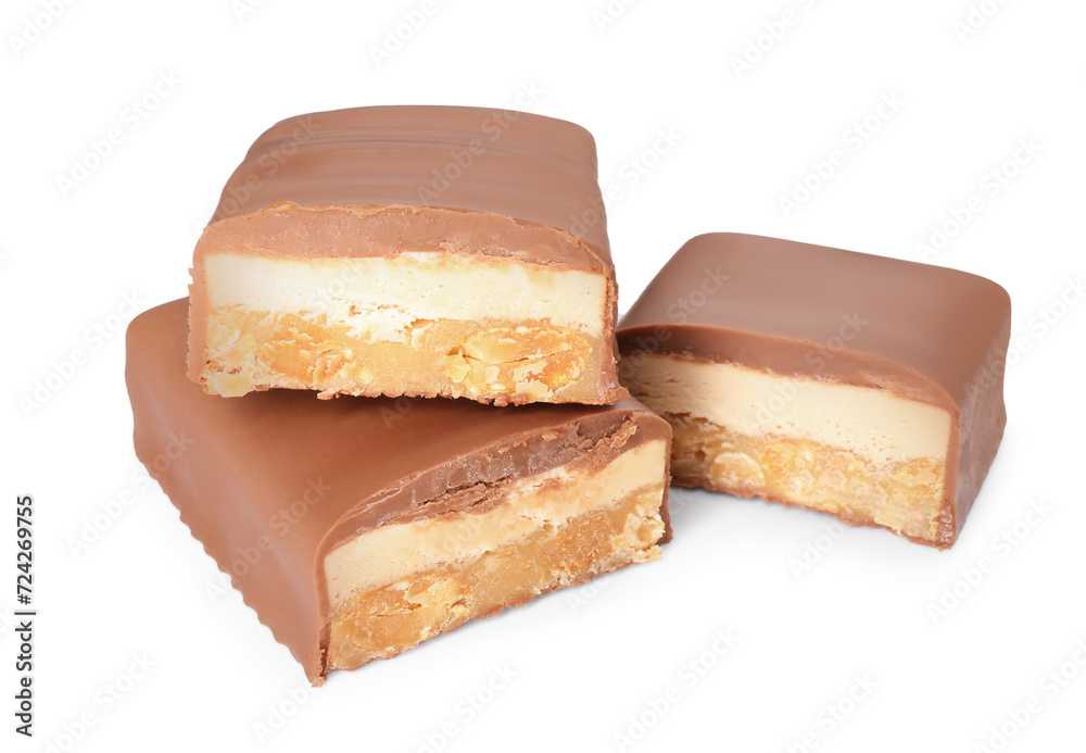 Pieces of tasty chocolate bars with nougat and nuts on white background Pieces of tasty chocolate bars with nougat and nuts on white background