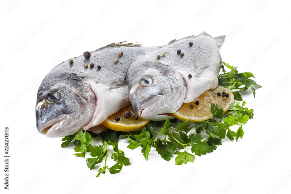 Raw dorado fish, parsley, lemon slices and peppercorns isolated on white