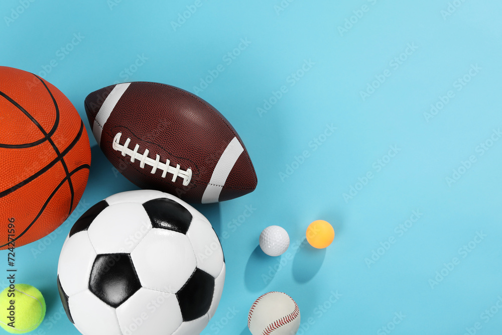 Many different sports balls on light blue background, flat lay. Space for text