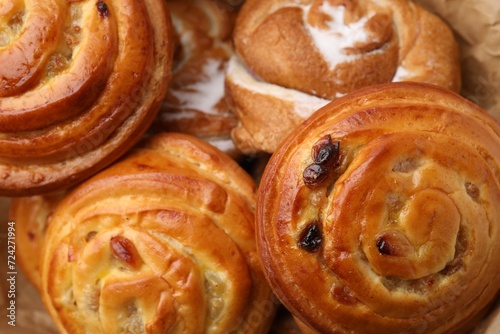 Delicious rolls with raisins and sugar powder as background, closeup. Sweet buns