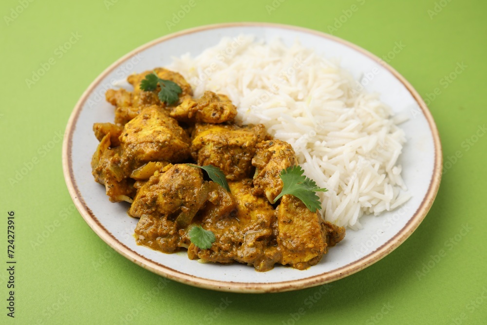 Delicious chicken curry with rice on green background, closeup Delicious chicken curry with rice on green background, closeup