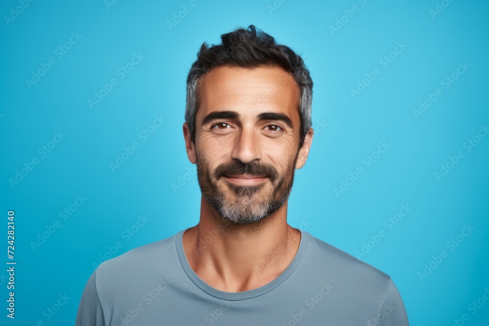 Portrait of handsome young man with beard and mustache on blue background Portrait of handsome young man with beard and mustache on blue background