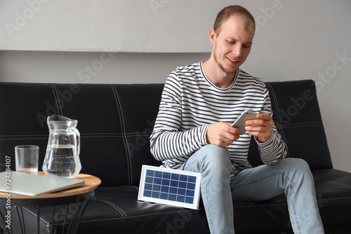 Young man using mobile phon...