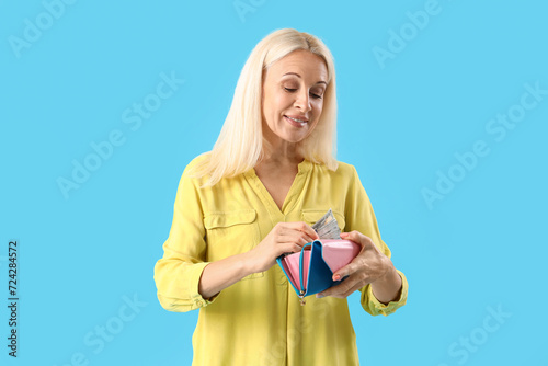 Mature woman putting dollar...