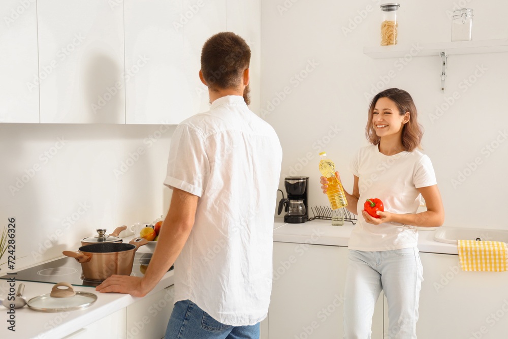 Happy couple in love boiling pasta in kitchen Happy couple in love boiling pasta in kitchen