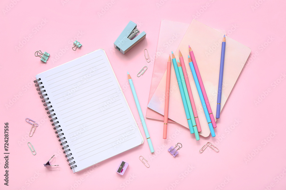 Many colorful pencils with stationery on pink background Many colorful pencils with stationery on pink background