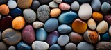 Vibrant close up of smooth beach pebbles with bright colors and sunlight