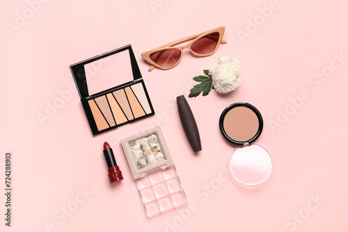 Composition with makeup products and beautiful flower on pink background