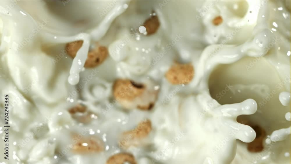 Corn flakes fall into the milk. Filmed on a high-speed camera at 1000 fps. High quality FullHD footage Corn flakes fall into the milk. Filmed on a high-speed camera at 1000 fps. High quality FullHD footage
