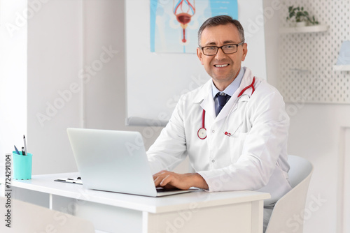 Mature doctor working with ...