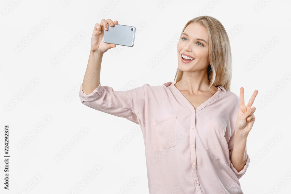 Portrait of attractive woman making selfie photo on smartphone isolated on white background. Influencer blogging vlogging online for social media Portrait of attractive woman making selfie photo on smartphone isolated on white background. Influencer blogging vlogging online for social media
