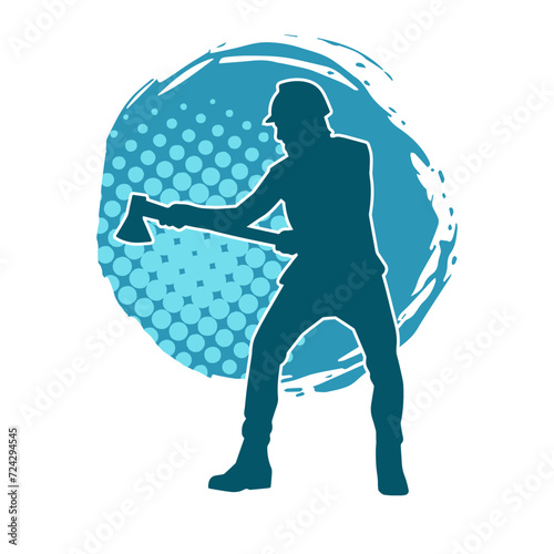 Silhouette of a worker in action pose using his axe tool.