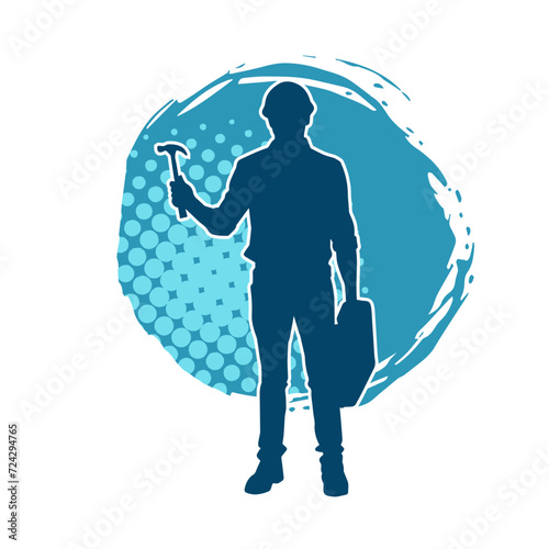 Silhouette of a worker carrying hammer tool. Silhouette of a worker in action pose using hammer tool.