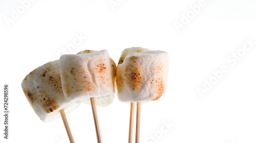 Bamboo sticks with roasted marshmallows isolated  on white background